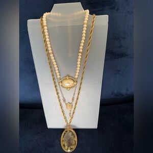 1928 Brand of three gold necklaces with pearl, rhinestone, and rose accents.